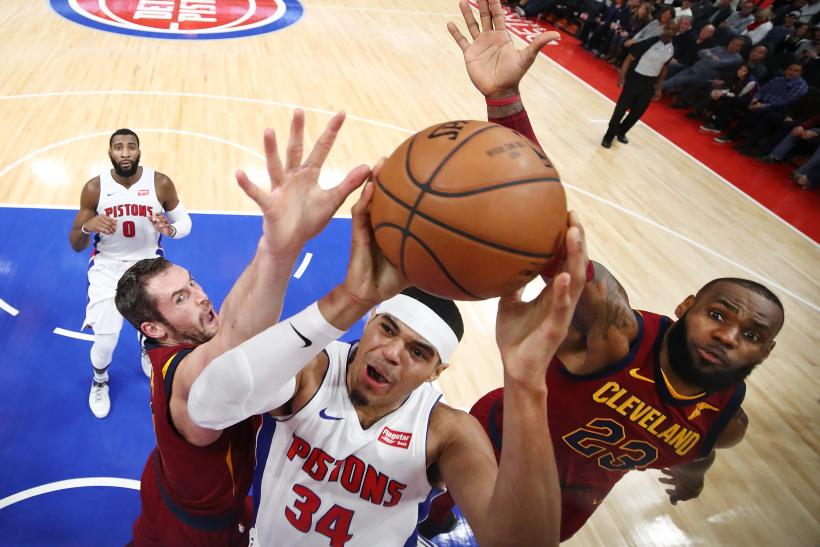 A group of basketball players attempting to score